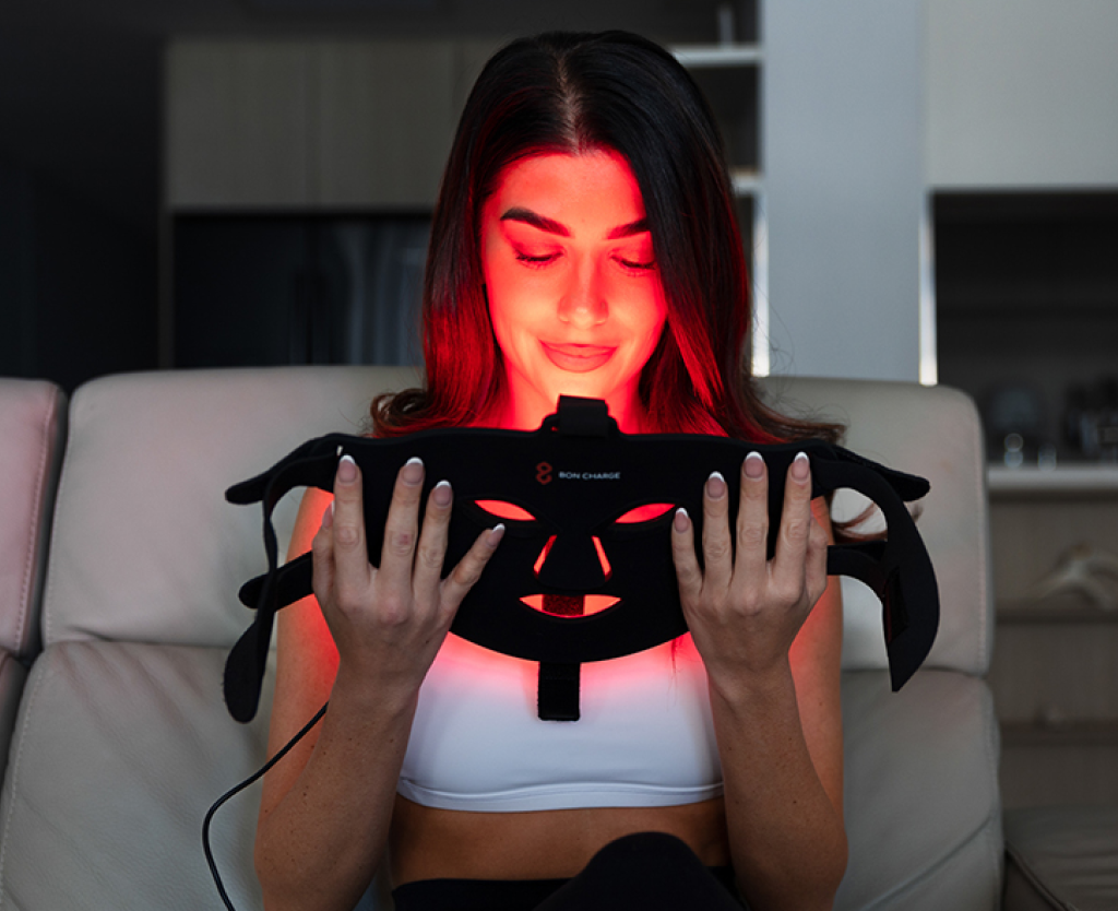 Woman Holding Red Light Face Mask