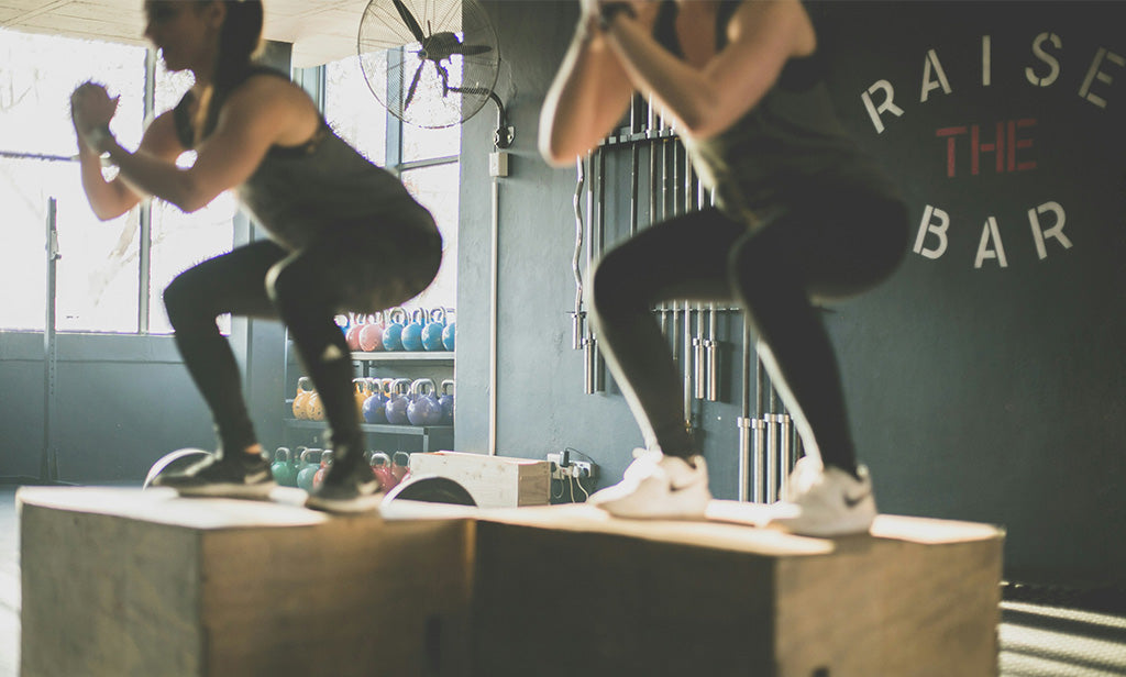 Woman In Gym Class Doing Squats