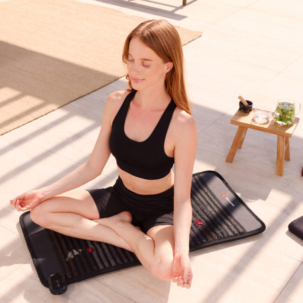 Woman Using Infrared PEMF Mat Demi