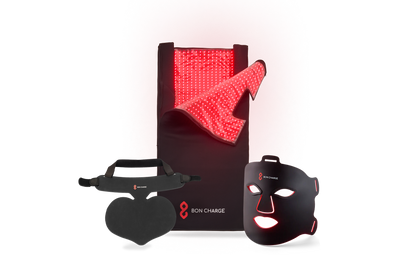 Red light face mask, next to a red light neck and chest mask with a red light blanket above un-zipped glowing red